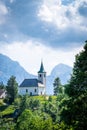 Church Cerkev Sveti Duh with mountain range KamnikÃ¢â¬âSavinja Alps Royalty Free Stock Photo